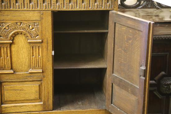 A carved and panelled oak wardrobe fitted two doors with matching compactum and dressing table, wardrobe W.104cm, D.55cm, H.178cm